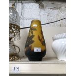 A yellow glass vase with leaf pattern