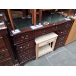 A reproduction pedestal desk.