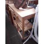 A light wood kitchen utility trolley.