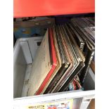 A box of vinyl Lps, singles and books