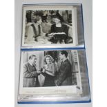 A folder of film press pack type photographic prints.