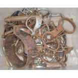 A crate of various antique handcuffs, ankle braces, and neck collars etc.