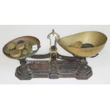 A set of vintage Avery cast metal and brass kitchen scales with weights, marked "W&T Avery To