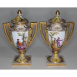 A pair of "Vienna" porcelain urns with lids, each bearing beehive mark to base, height 15cm.