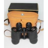 A pair of Pearl 10x50 binoculars with leather case and box.