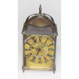 A brass "Lantern" style clock with spring driven movement, height 14cm.