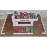 A vintage wooden garage and play worn die-cast model vehicles including Dinky, Corgi and Lesney
