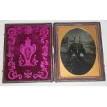 A Victorian ambrotype depicting a soldier within leather case, image approx. 7cm x 9.5cm.