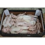 A box containing 9 ceramic dolls in a variety of sizes.