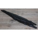 A carved wooden crocodile, length 59cm.