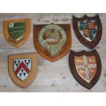 A group of five heraldic shields.