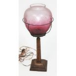 An oak table lamp with etched glass shade, height 47cm.