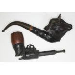 Twi vintage pipes, one formed as a pistol and the other a bull's head.