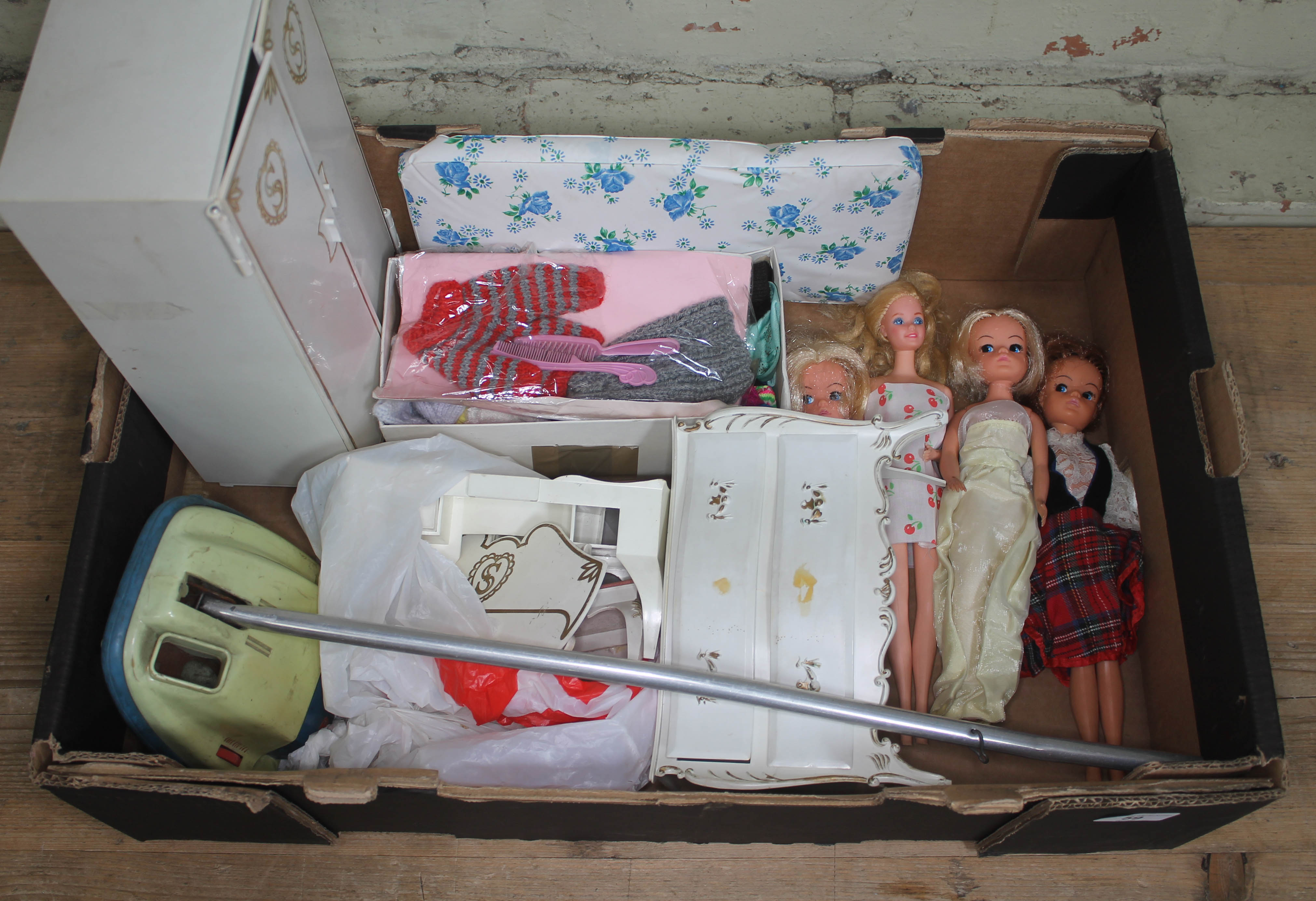 A collection of four dressed Barbie dolls, together with a shoe box of clothes and accessories,