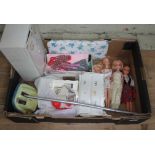 A collection of four dressed Barbie dolls, together with a shoe box of clothes and accessories,