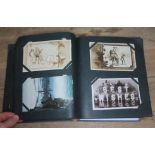 An album containing approx. 150 antique and vintage postcards.