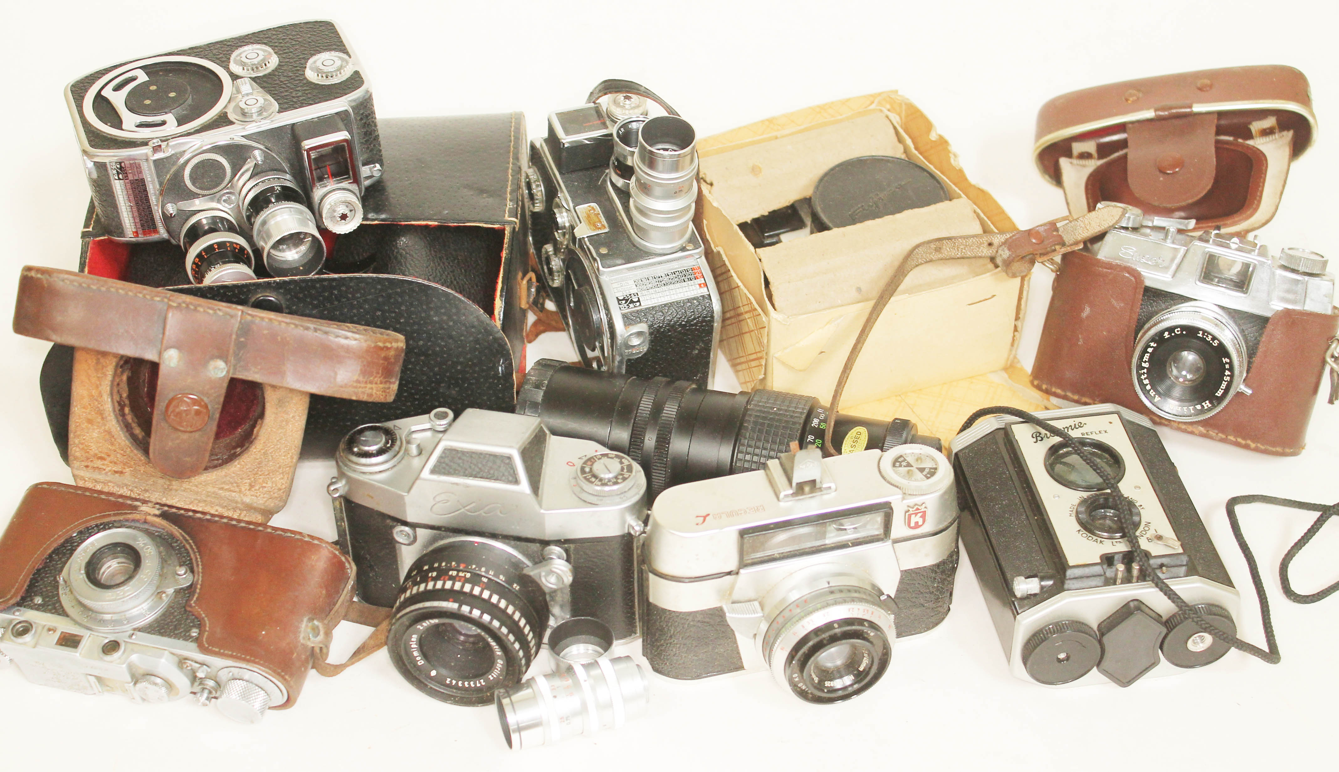 A box of cameras and accessories including a Thagee Dresden Exa II, two Bolex Paillard cameras and a