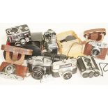 A box of cameras and accessories including a Thagee Dresden Exa II, two Bolex Paillard cameras and a