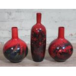 A group of three Royal Doulton flambe vases, tallest 35cm.