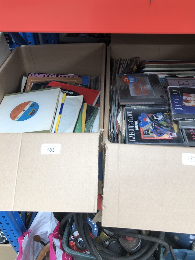 Two boxes of vinyl singles and cds
