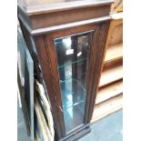 A glazed tall display cabinet