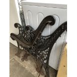 A pair of cast metal bench ends