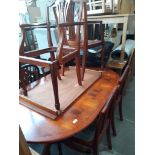A reproduction yew wood extending dining table and 6 chairs
