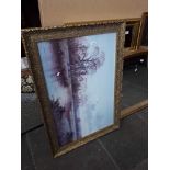 A large landscape print in ornate frame