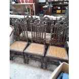 A set of 6 carved oak and bergere seat high back chairs