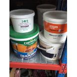 Tubs of various paints and fence treatment