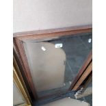 An oak framed bevelled edge mirror