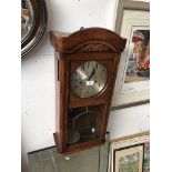 An oak cased steel dial wall clock
