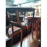 An early 20th century mahogany oval side table with basket style lower tier