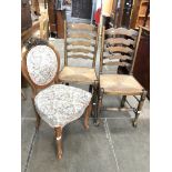 An antique continental style upholstered chair and two rush seat ladder back chairs