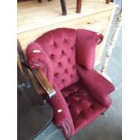 A child's chesterfield style winged back armchair.