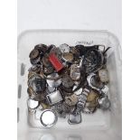 A tub of watch parts
