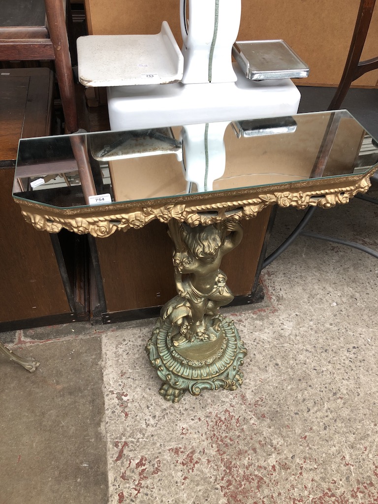 An ornate gilt cherub console table
