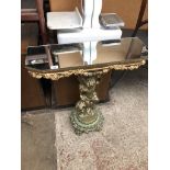 An ornate gilt cherub console table