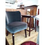 An upholstered mid 20th century chair and a carved top table