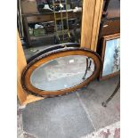 A large oak framed bevelled mirror approx 82cm x 54cm