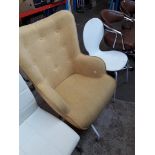 A retro style button back swivel armchair