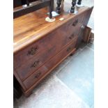 A walnut cross banded chest of drawers with brass swan neck handles