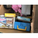 A box of vintage lunch boxes, empty toy boxes, doll, etc