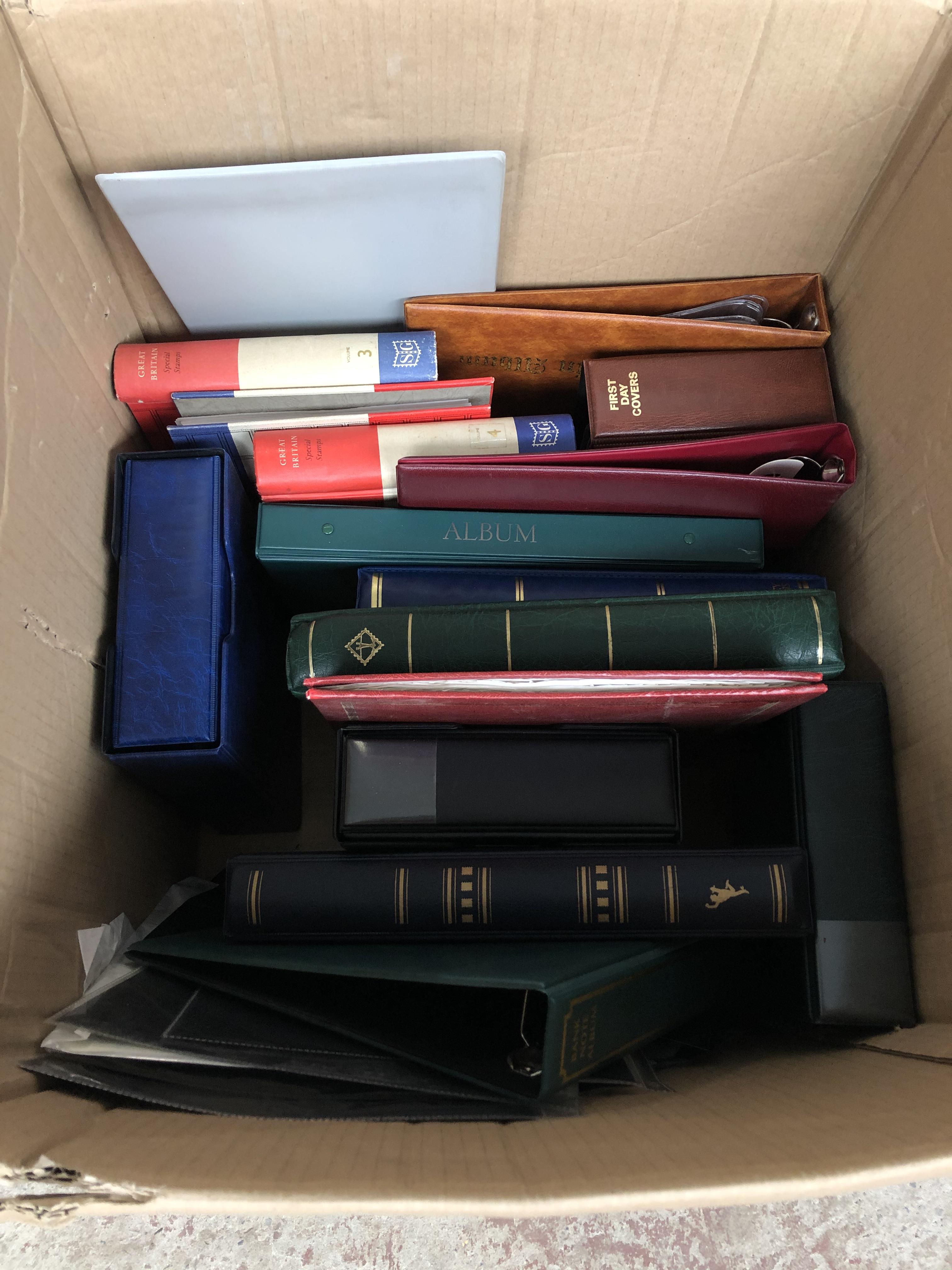 A large box of empty stamp, coin and postcard albums