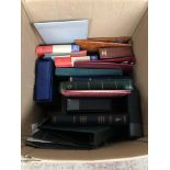 A large box of empty stamp, coin and postcard albums