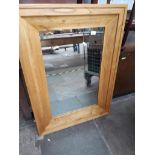 A large light oak mirror