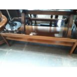 A teak and glass top coffee table