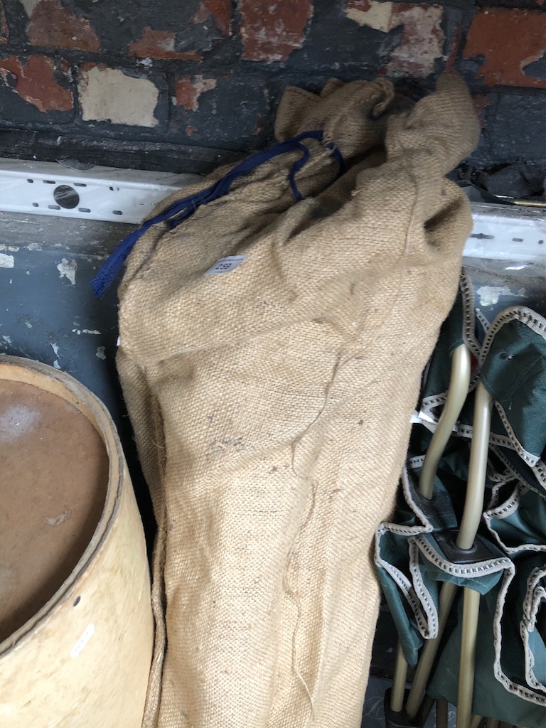 A hessian bag with tent poles