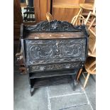 A carved oak bureau