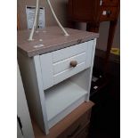 A modern white bedside cabinet